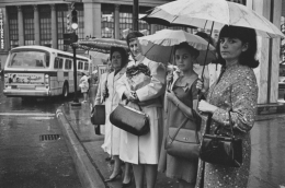 Women waiting at a bus stop in the rain, Detroit, 1968