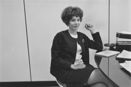 Secretary smoking at her desk, Detroit, 1968